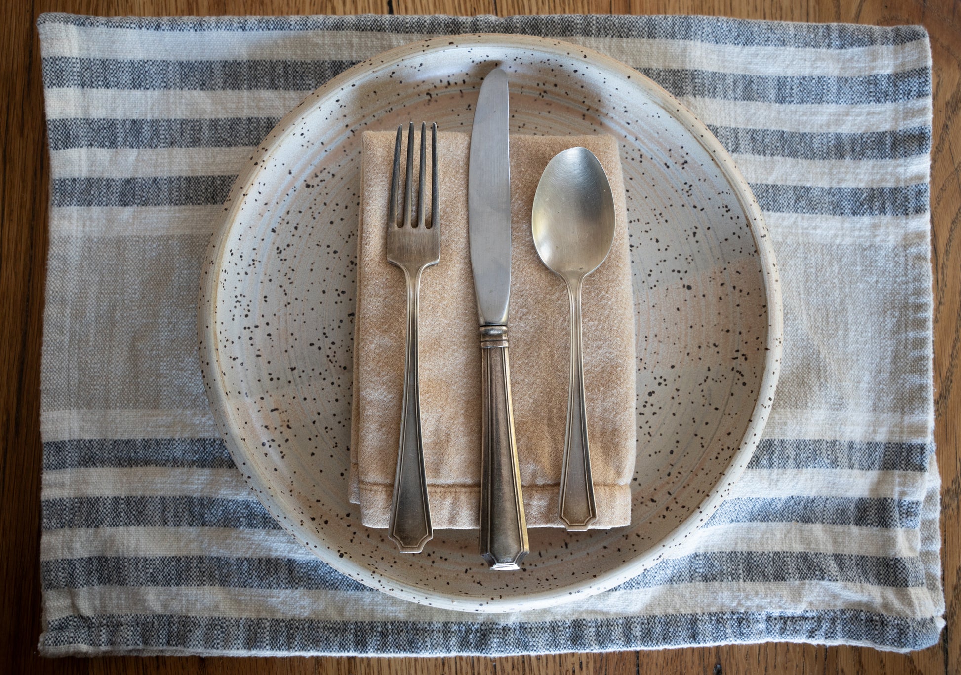 Minimalist handmade pottery by MK Clayworks, styled on a modern table for a warm, inviting dining experience.